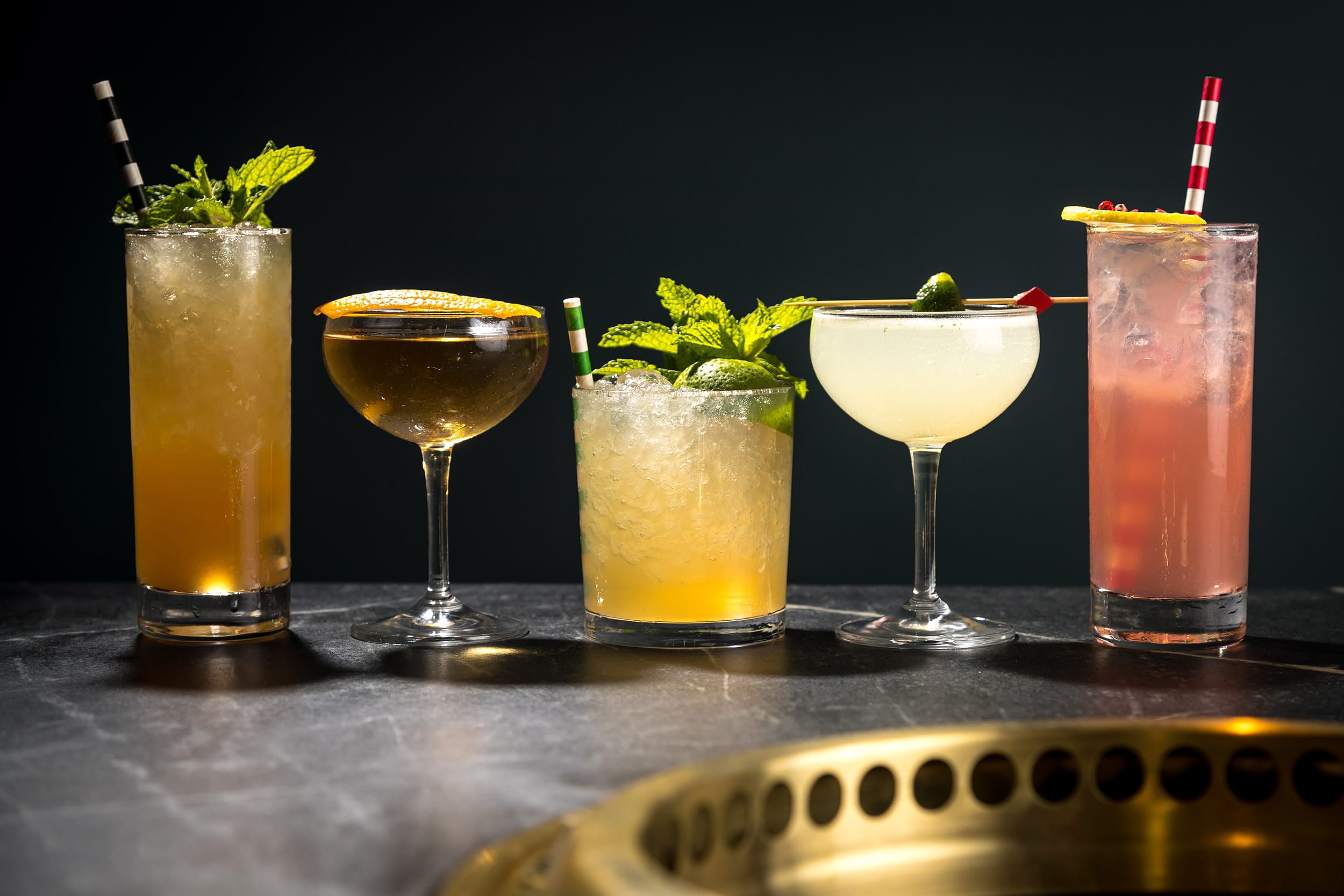 Five unique cocktails on a table
